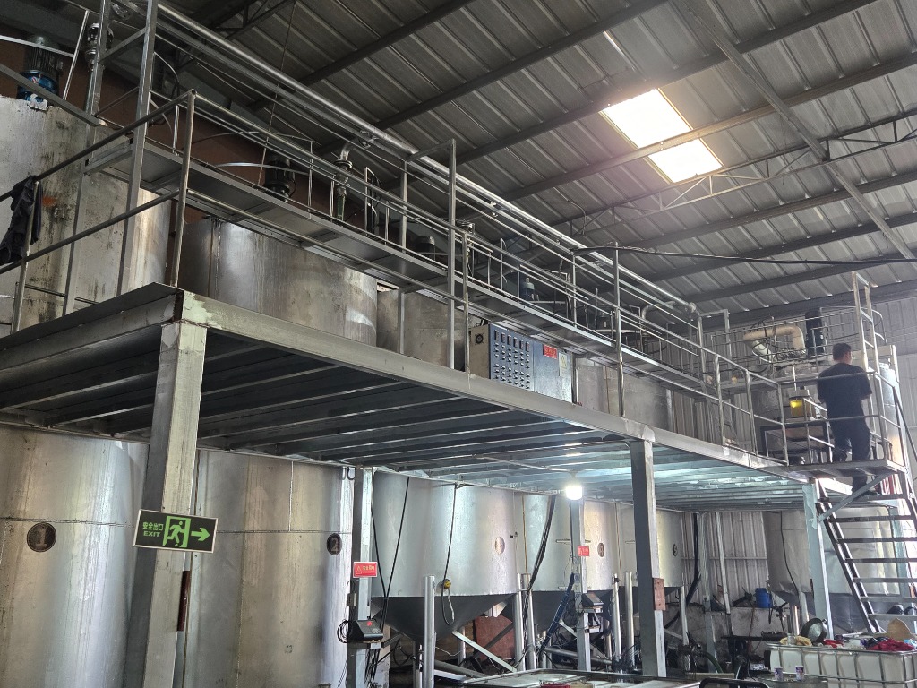 Two-level industrial mezzanine blending plant with electrical control console and conical kettles