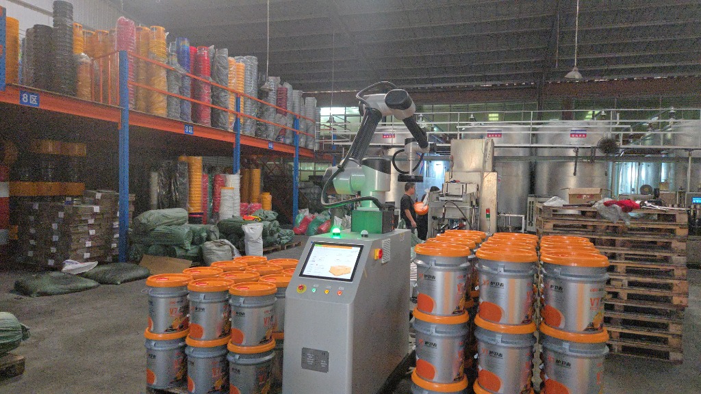 High-tech 6-axis robotic palletizing arm with touchscreen interface stacking lubricant pails onto pallets